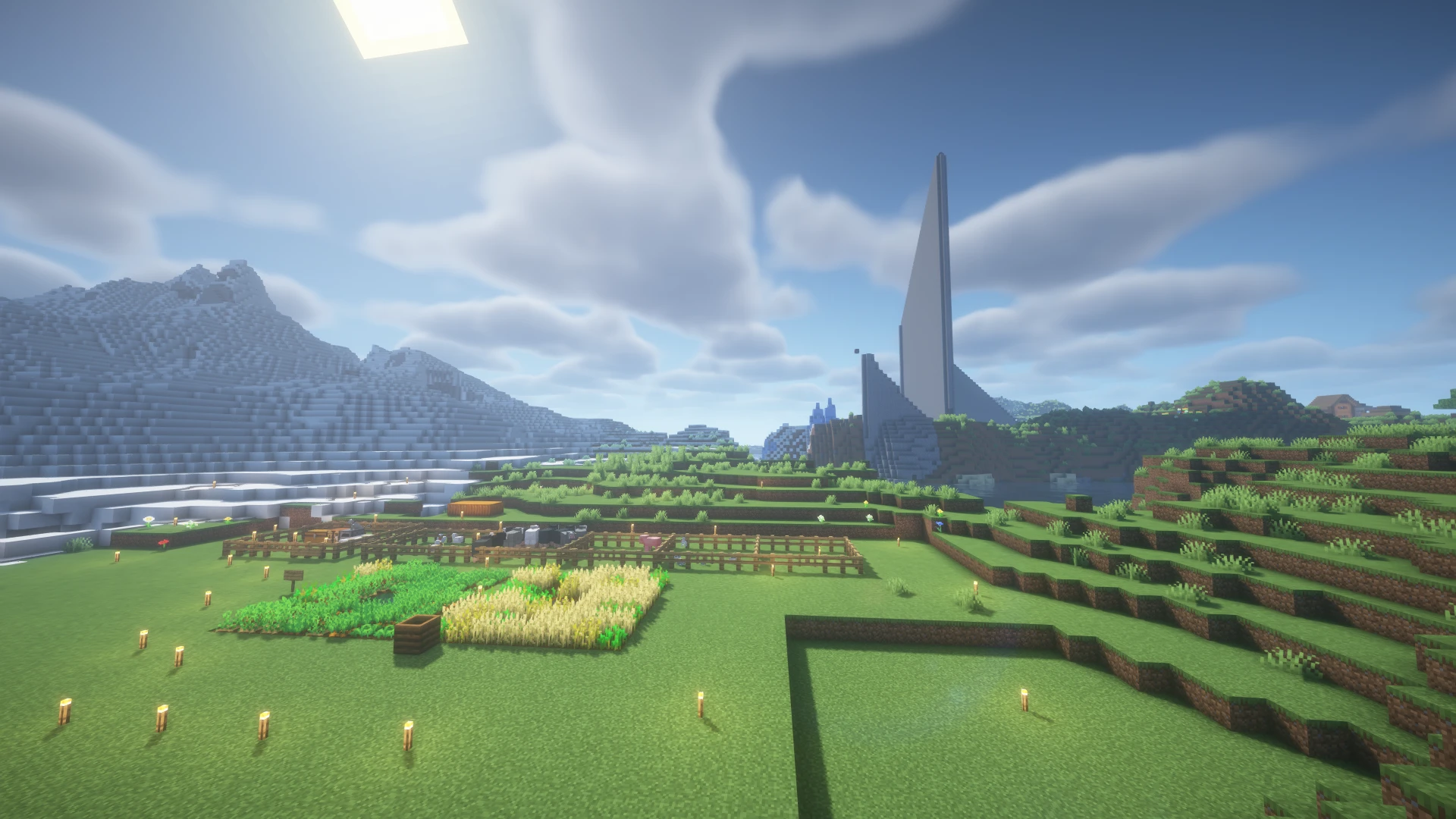 Torchlit farms beneath the spawn obelisk